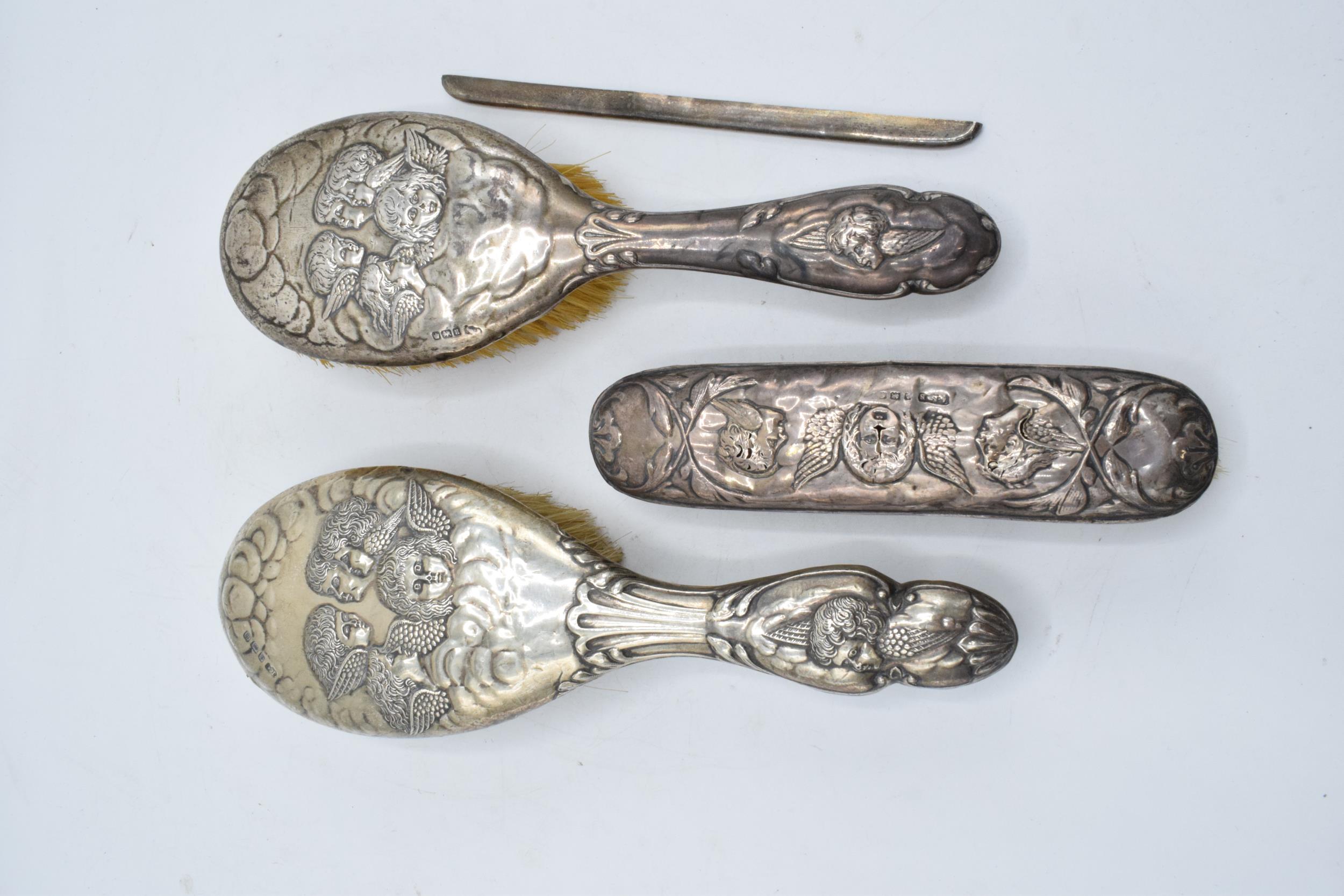 A collection of silver items in the Reynolds Angels design to include 2 large brushes, a smaller