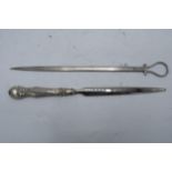 A silver handled letter opener together with a silver plated meat skewer (2).