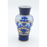 A Macintyre / Moorcroft small baluster vase with stylised decoration. 11cm tall. In good condition