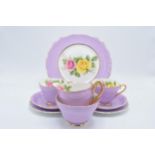 A pink and floral china tea set to consist of 6 trios, milk, sugar and a cake plate (21 pieces).