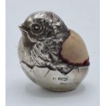 A novelty silver pin cushion modelled as a baby bird hatching from a broken egg shell. Sampson