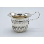 An ornate silver cream jug / sauce jug. London 1890. 53.7 grams. In good condition with some dents