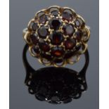 A 9ct gold dress ring set with garnet stones. 3.6 grams.