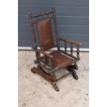 An early 20th century wooden childs American-style bobbin rocking armchair. 72cm tall. In good