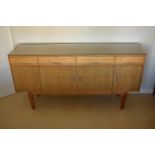 Gordon Rusell Limited four-door mid-century / retro sideboard on tapered legs with 4 drawers too.