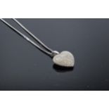 9ct white gold and diamond heart puff pendant set with approximately 0.15 carat of diamonds on a 9ct