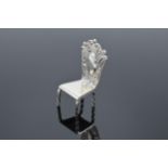 Silver (925) miniature model of a hall chair. 10.8 grams. 5cm tall.