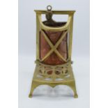 An early 20th century brass and copper fireside trivet / companion set holder. 28cm tall.