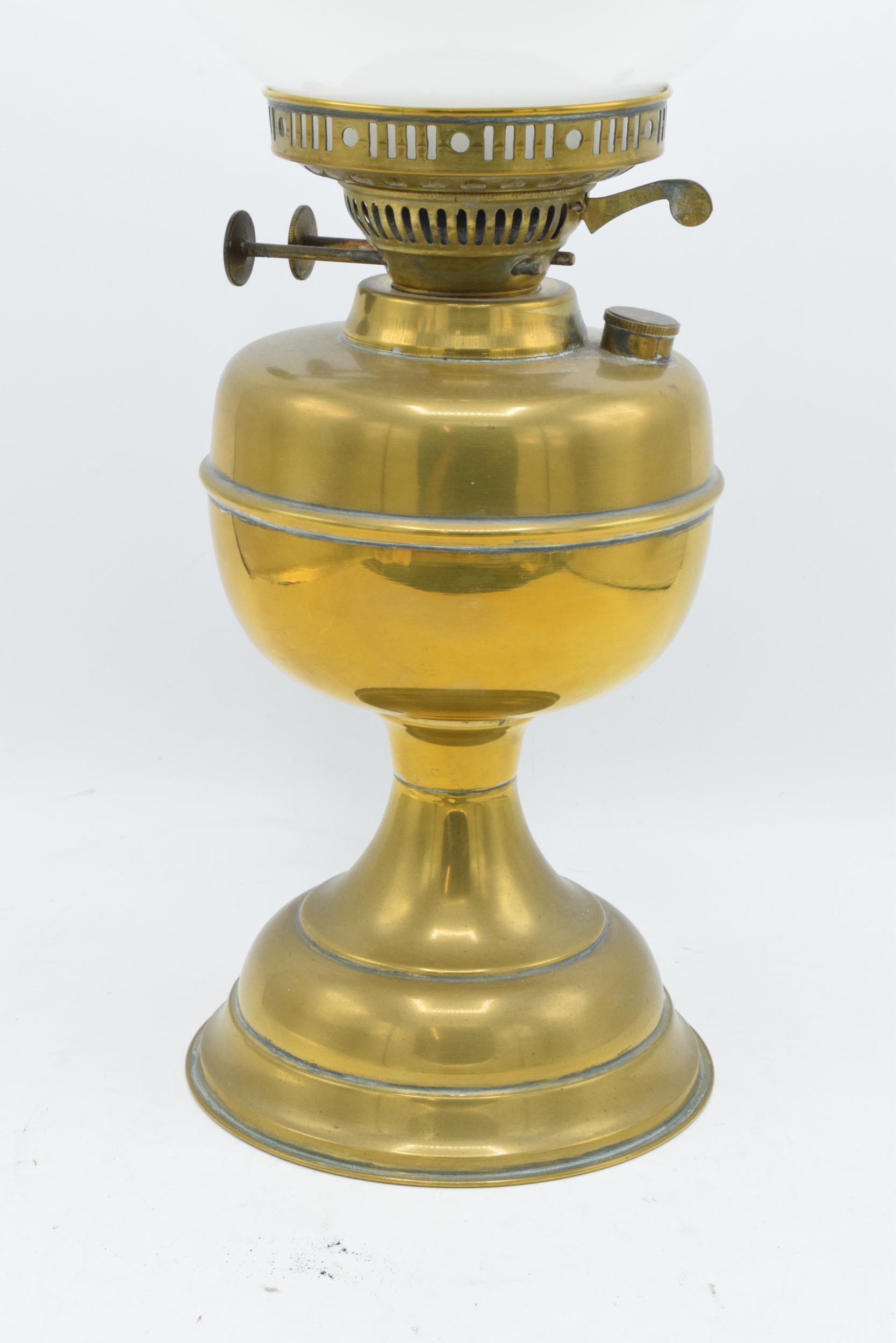 An early 20th century brass oil lamp with associated chimney and shade. 28cm tall without shade. - Image 2 of 3