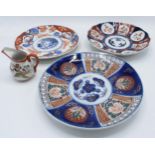 A collection of oriental pottery to include Two Japanese Imari plates, together with a modern