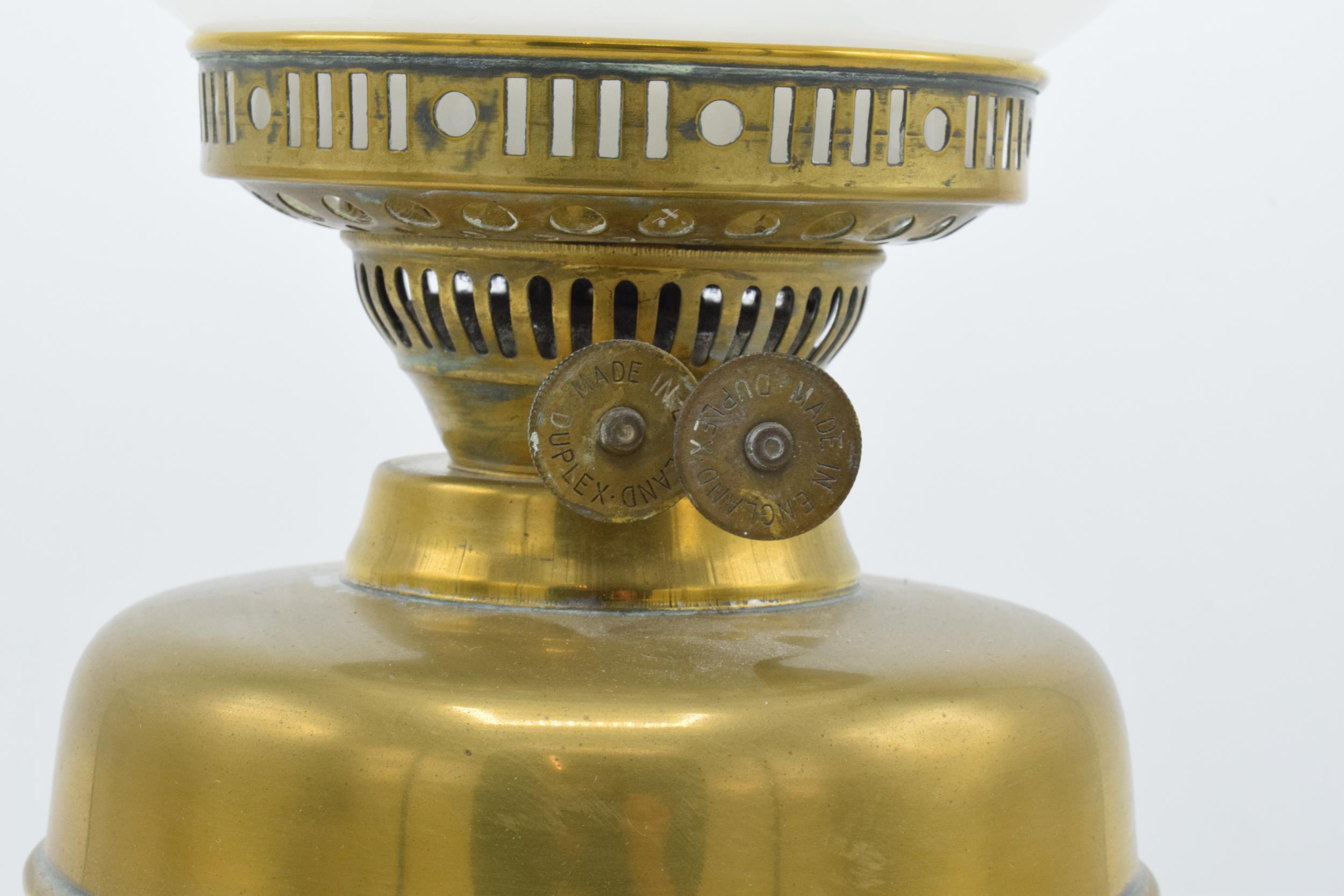 An early 20th century brass oil lamp with associated chimney and shade. 28cm tall without shade. - Image 3 of 3