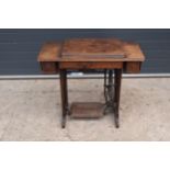 An early 20th century folding Singer sewing machine table. All folds / expands well. Untested. 87