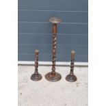 A collection of 1930s oak barley twist candlesticks, possibly from a church / chapel. 64cm tallest.