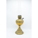 A 20th century brass oil lamp with an associated shade. 32cm tall without shade. 'Best English Make'