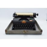 Lilliput cased typewriter with original instructions. Appears in good condition though untested.
