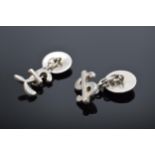 A pair of silver (925) cufflinks in the form of a dollar and a pound sign. 8.7 grams.