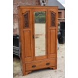 An Edwardian satinwood wardrobe with central mirror. 107 x 43 x 187cm tall. In good condition with