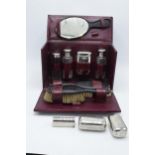 An early 20th century travelling vanity set in a leather carry case