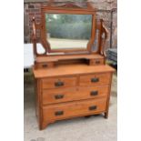An Edwardian satinwood mirror backed 2 over 2 chest of drawers. 108 x 45 x 165cm tall. In good