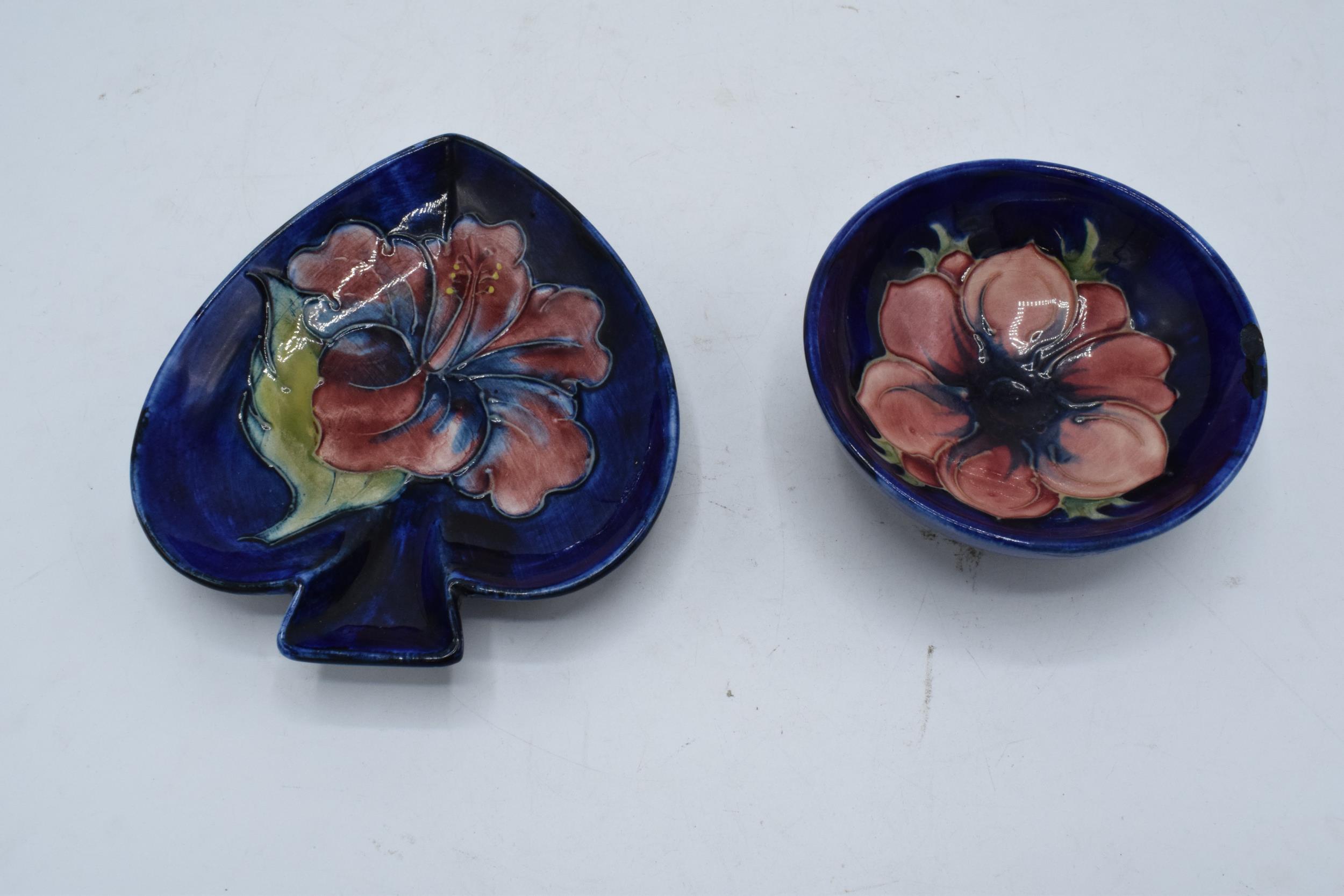 A pair of Moorcroft items to include a hibiscus on blue spade-shaped ashtray together with a similar
