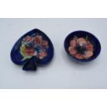 A pair of Moorcroft items to include a hibiscus on blue spade-shaped ashtray together with a similar