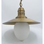 A reproduction ceiling light in the style of a brass industrial lamp 'Queen of the West'.