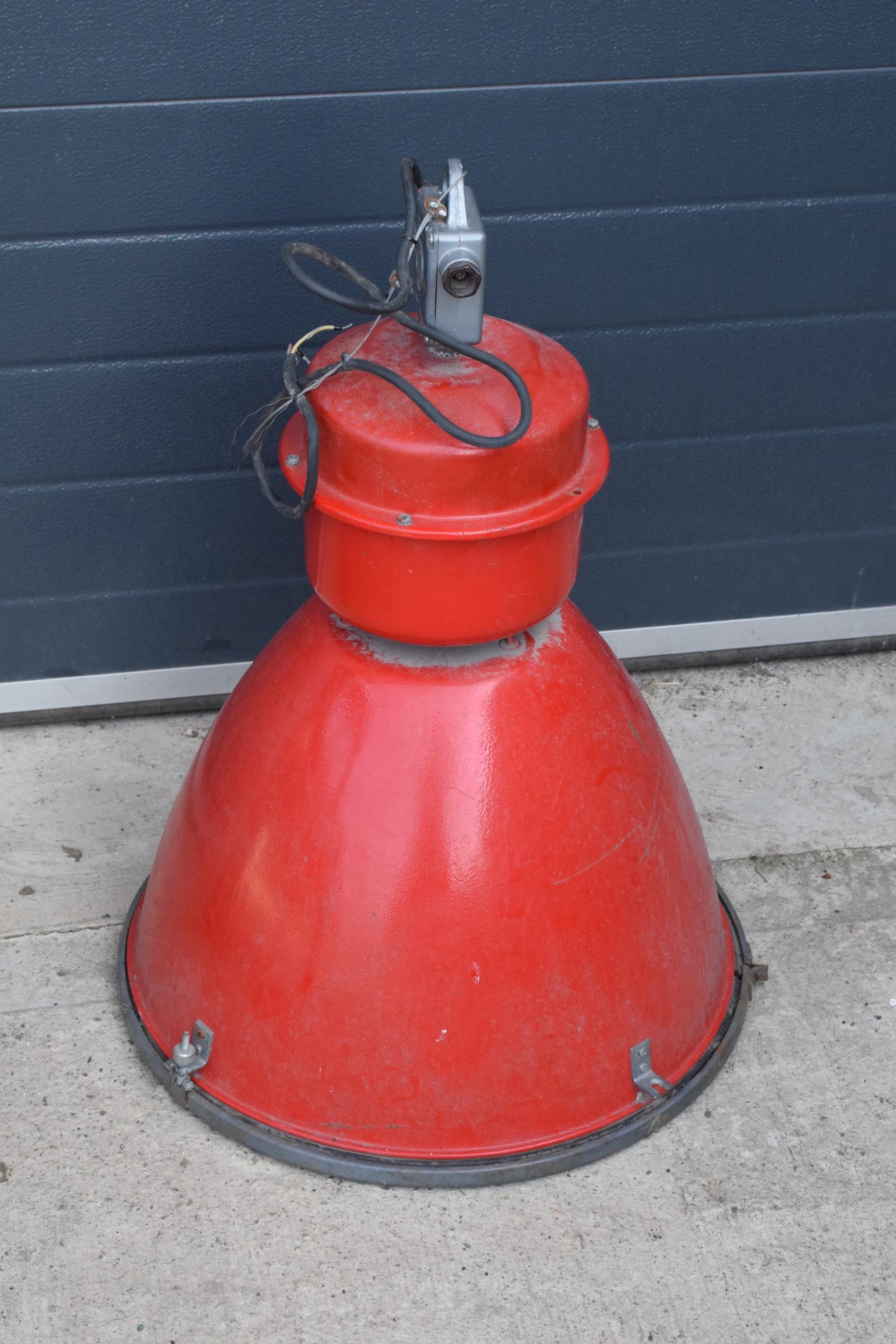 A large 20th century metal industrial hanging light in a red colourway. 72cm tall. Untested.