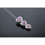 A 10ct white gold triple-heart pendant set with pink topaz and 3 diamonds on a 9ct white gold chain.