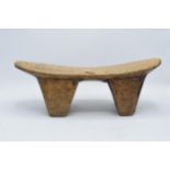 An early to mid 20th carved wooden headrest, believed to be of African origin. 43cm long.