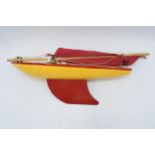 A vintage 20th century children's toy Star Yacht. Requires some attention to the sails. 36cm long.