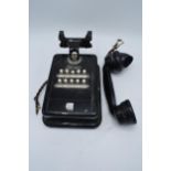 A 20th century wall mounted telephone for internal use with handset. There is some damage to the