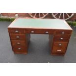 A 20th century knee hole office desk with green leather inset manufactured by Durrant. 137 x 69 x