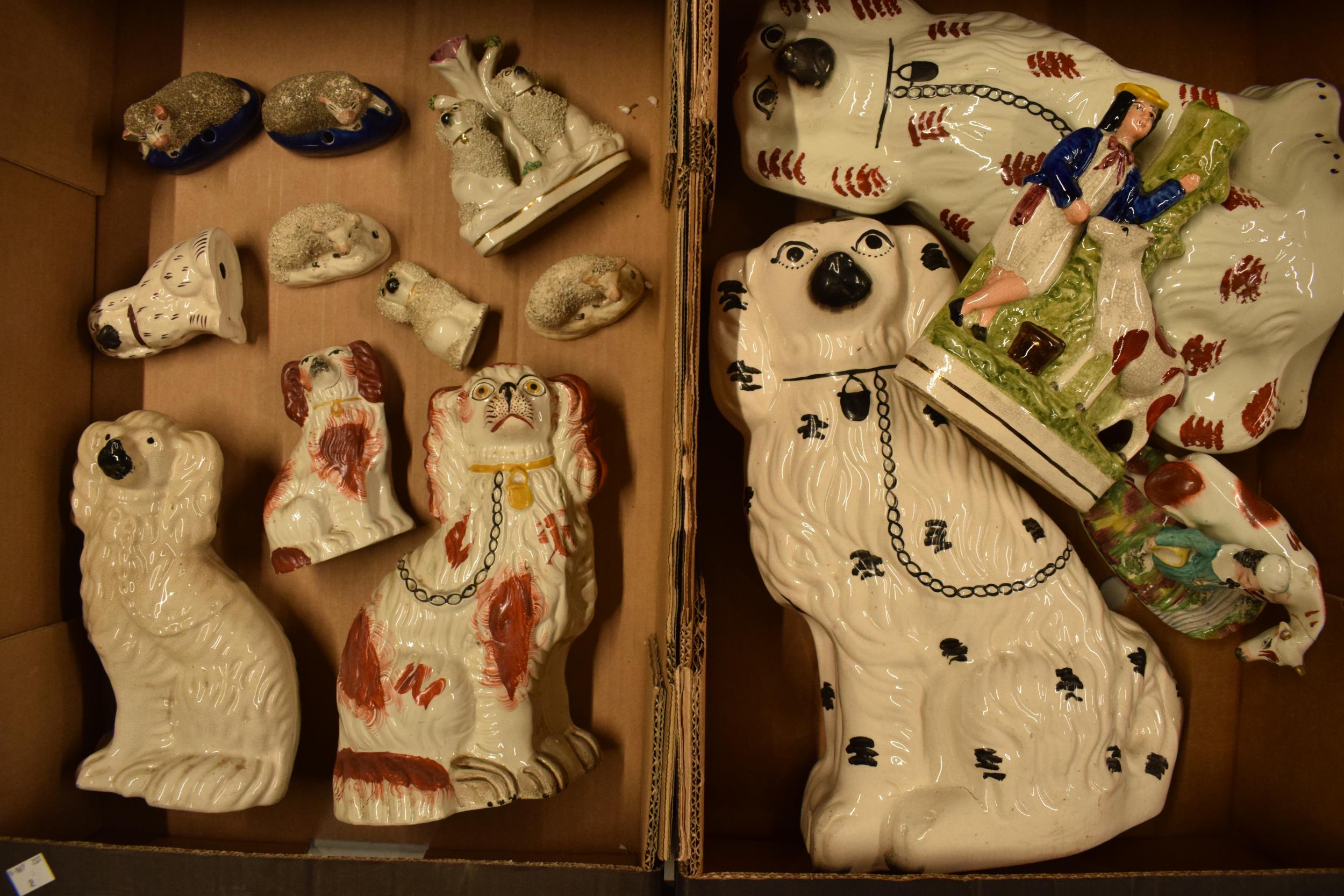 A collection of 19th and 20th century Staffordshire pottery to include dogs, sheep, flat backs