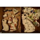 A collection of 19th and 20th century Staffordshire pottery to include dogs, sheep, flat backs