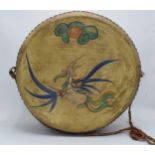 An unusual early to mid 20th century two sided drum with painted decoration. Perhaps from a fun