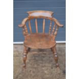 A late 19th century elm or similar Captains bow back arm chair. 79cm tall. In good condition with