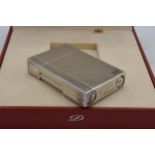 A boxed silver plated ST Dupont lighter