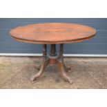 A 19th century walnut tilt-top occasional table with quarter veneered top with inlay decoration on