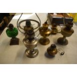 A collection of 20th century oil lamps and burners of various forms to include examples with