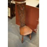 A 20th century carved wooden low chair on 4 turned legs (90cm tall, slightly loose joints)