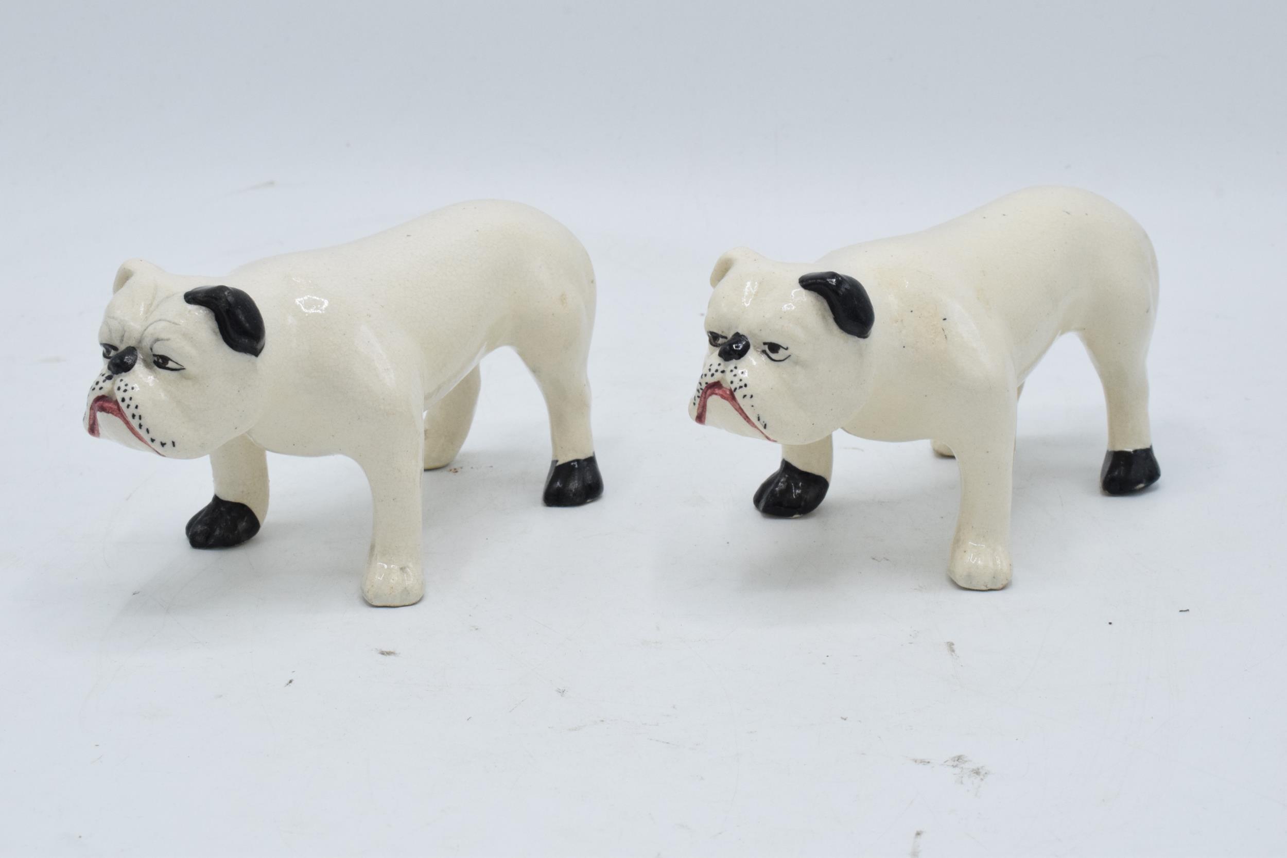 A pair of 19th century pottery bulldogs standing square (2). In good condition with no obvious