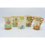 A collection of Wade Heath Art Deco jugs all with floral decorations (5). 13.5cm tall. Generally