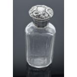 Edwardian glass scent bottle with a silver screw top lid with repousse decoration. London 1904. 10cm