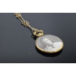 A 9ct gold double-sided share locket with hallmarks on an associated metal chain. Gross weight of