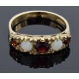 9ct gold ladies ring set with opal and garnet stones. 2.9 grams. Size O.