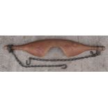 An antique wooden farmers yoke complete with original chains. 91cm wide. In good condition with