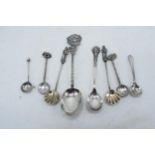 A collection of silver coloured and hallmarked silver mustard and similar spoons (8). 44.1 grams.