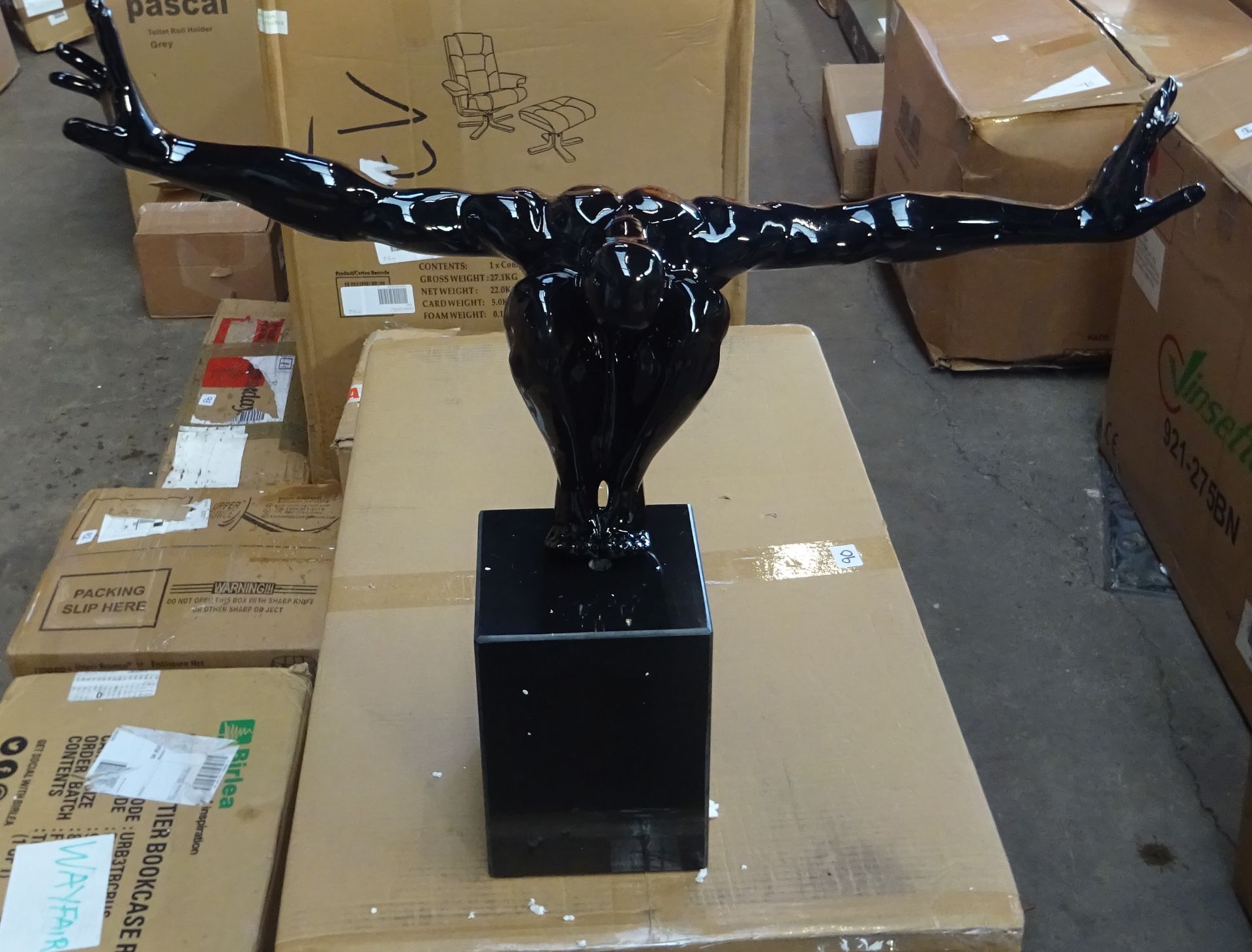 Black man sculpture with hands and black base