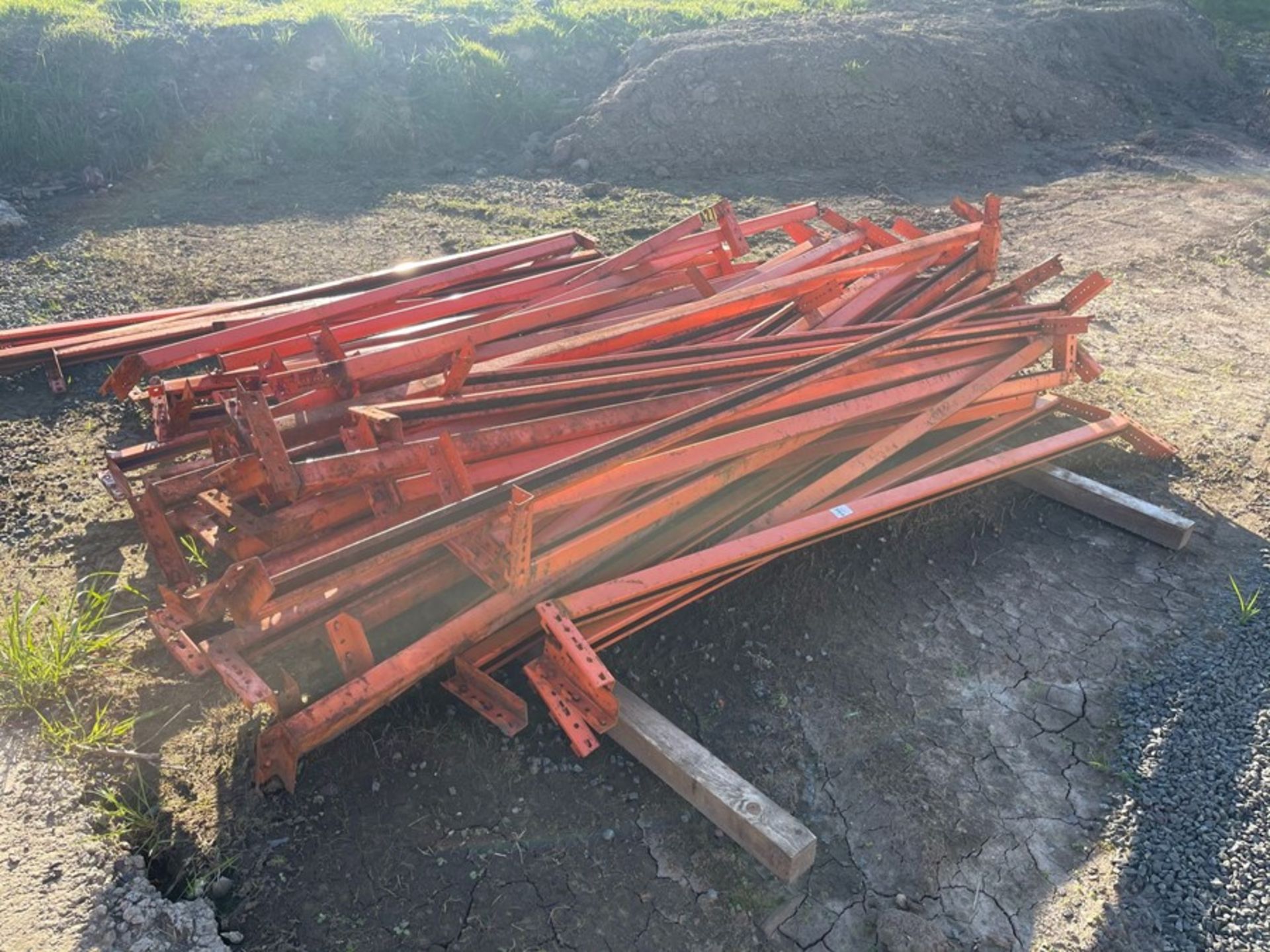 LARGE BUNDLE OF ORANGE STEEL RACKING BARS