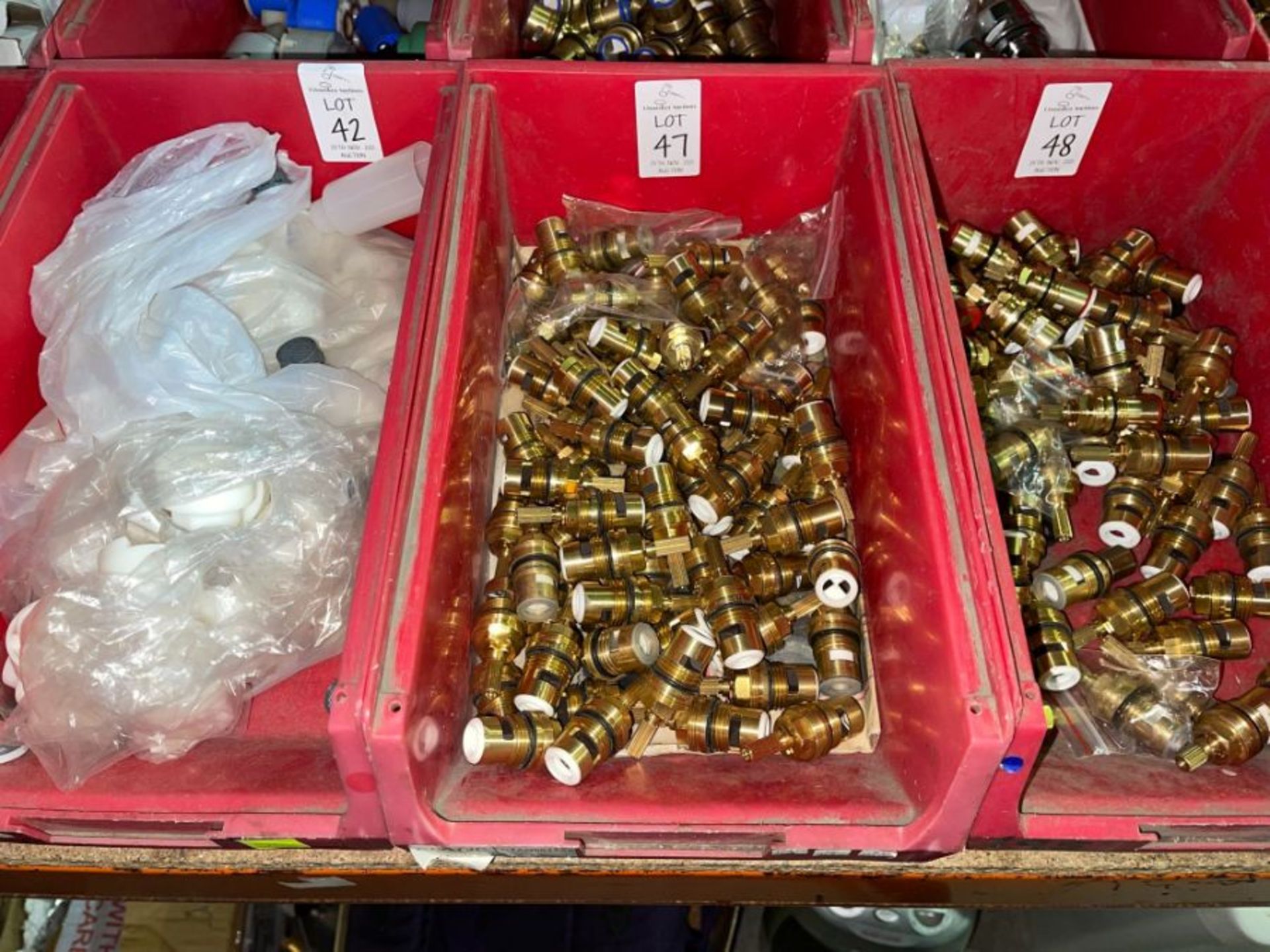 RED TUB OF BRASS FITTINGS